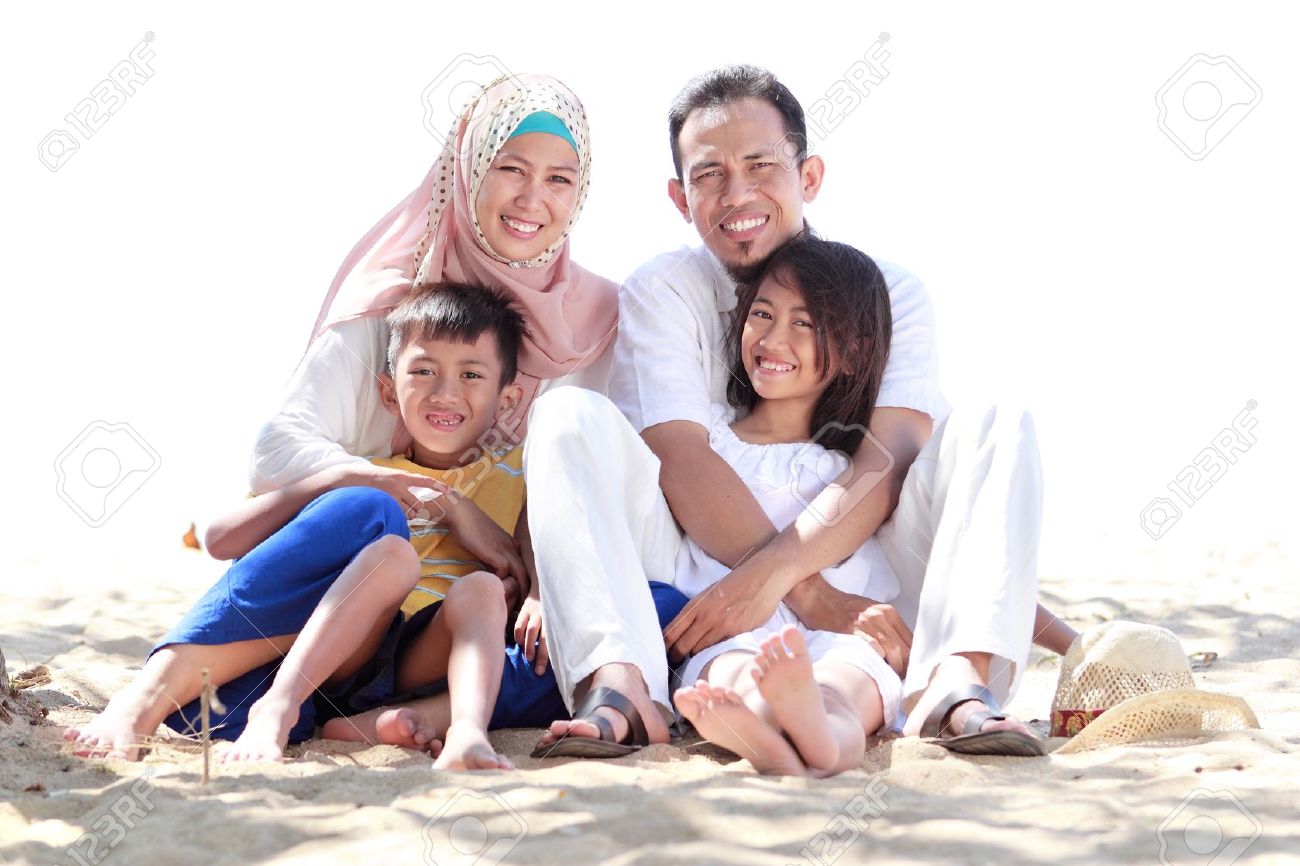 22085965 portrait of happy muslim family in the beach and looking at the camera